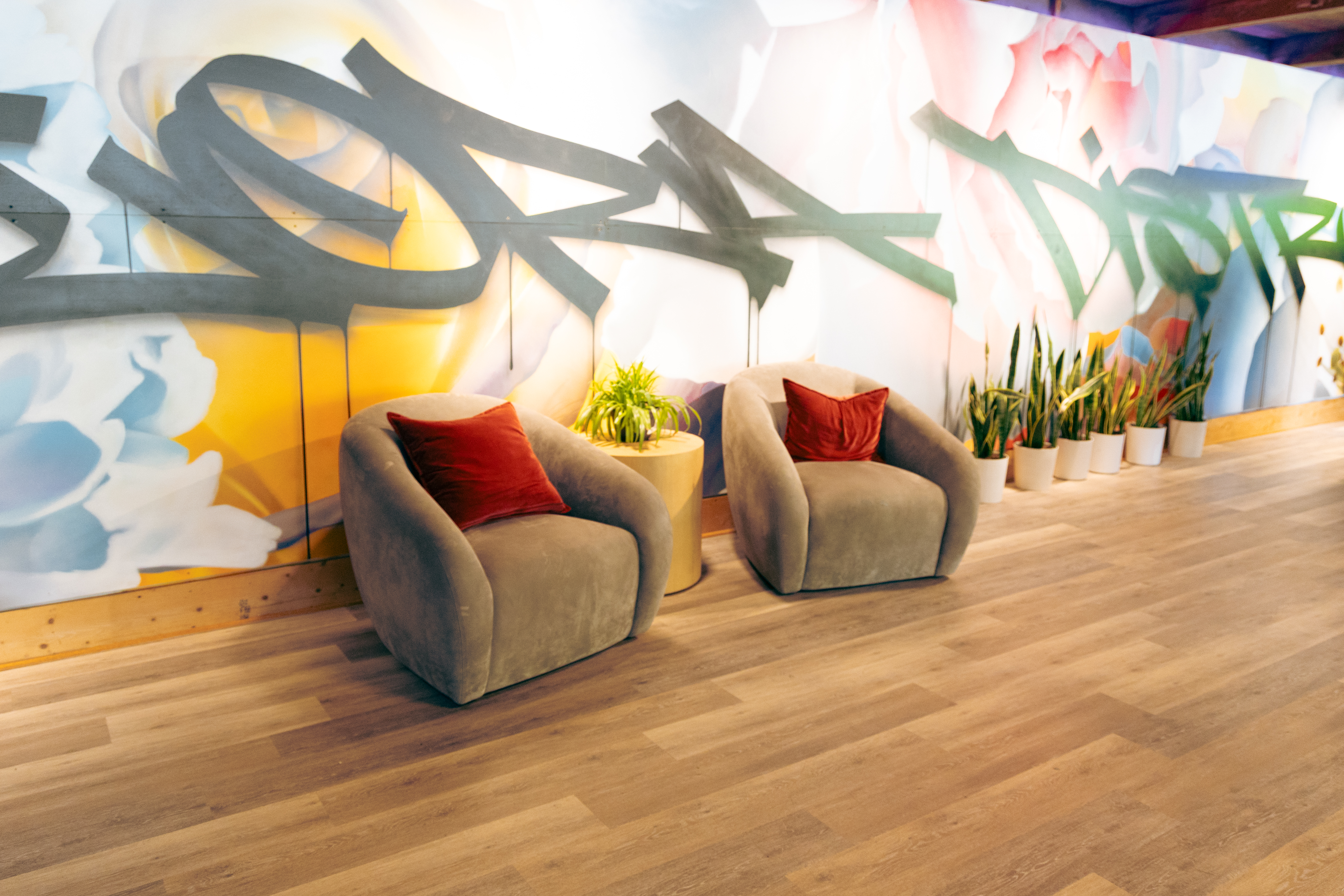 Velvet armchairs against graffiti mural