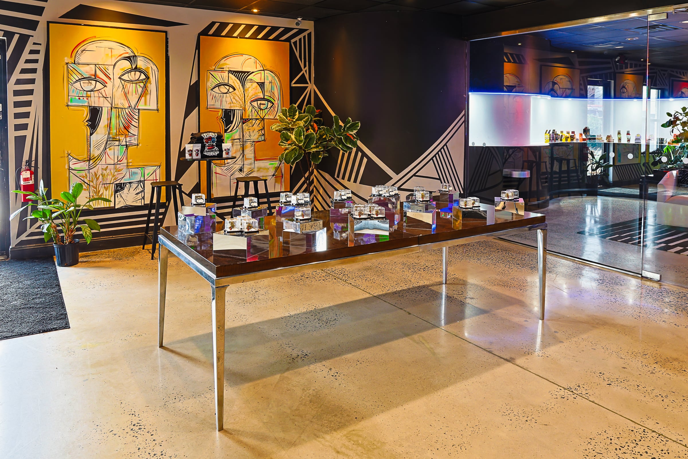 Display table with jars and murals