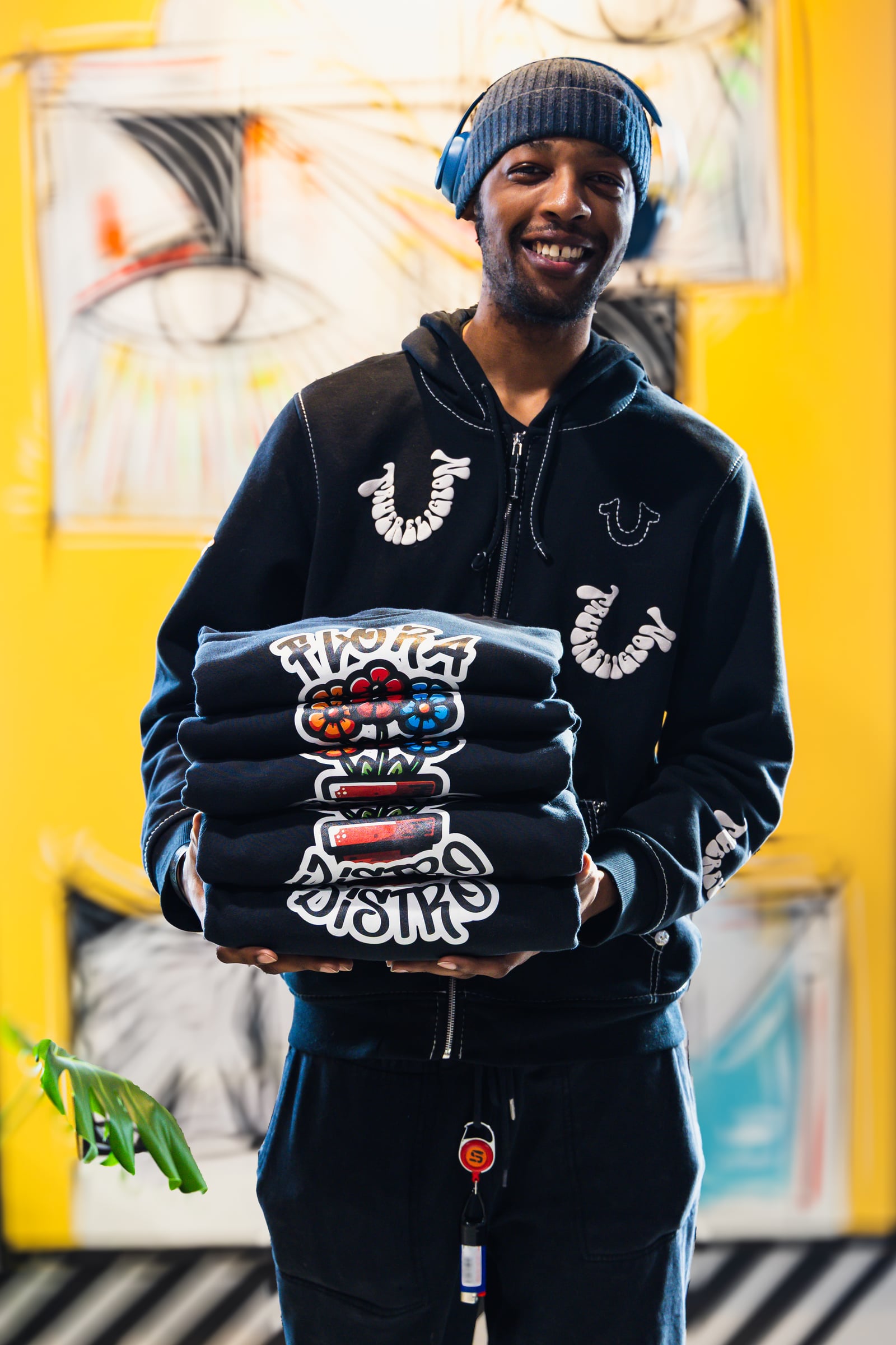 Staff member holding Flora tees