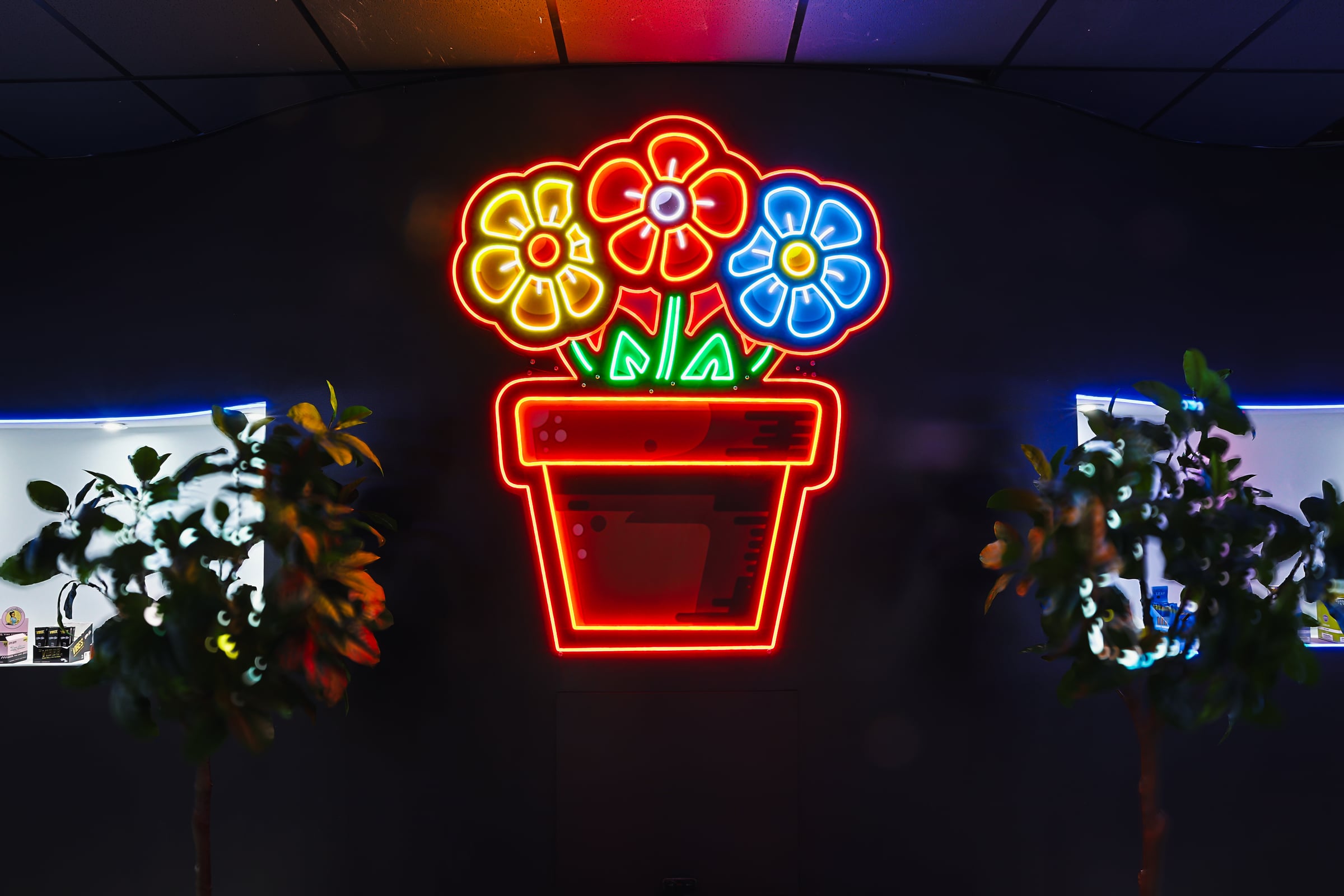 Neon flower pot sign closeup