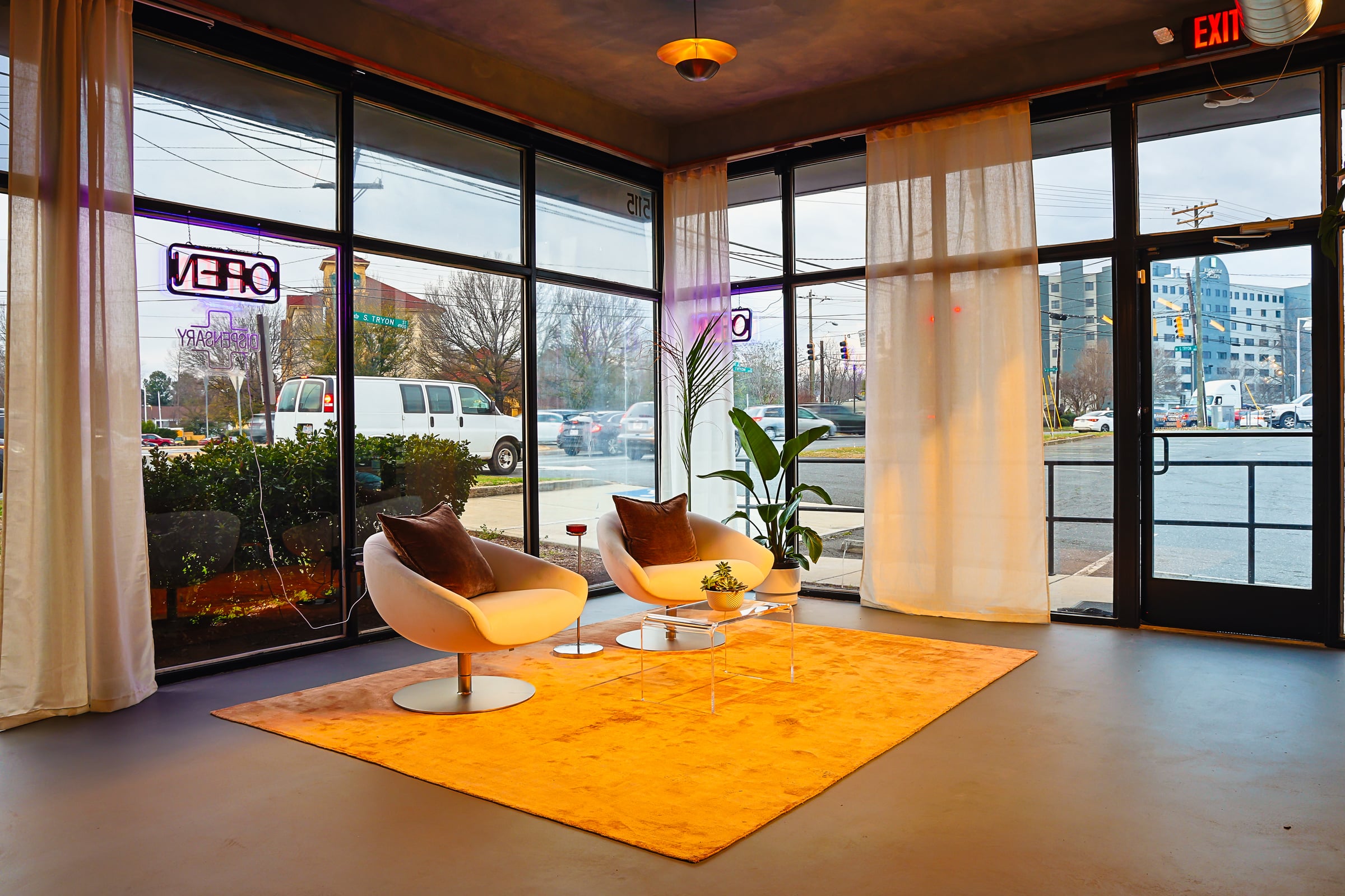 Orange rug with neon through window